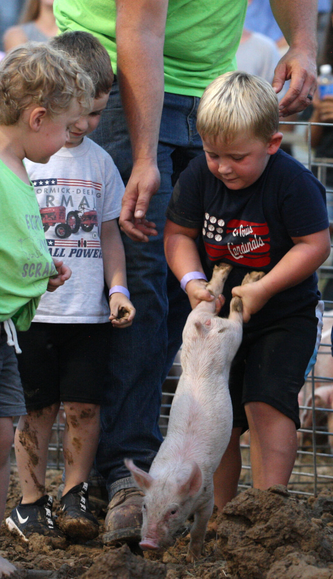 Dexter Hoemann grabs a piglet